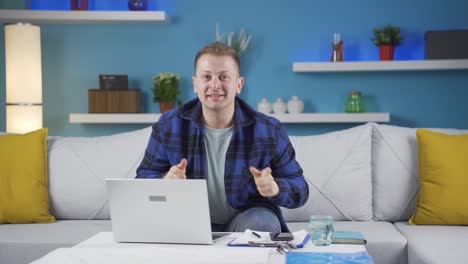 Home-office-worker-man-making-cute-gesture-at-camera.